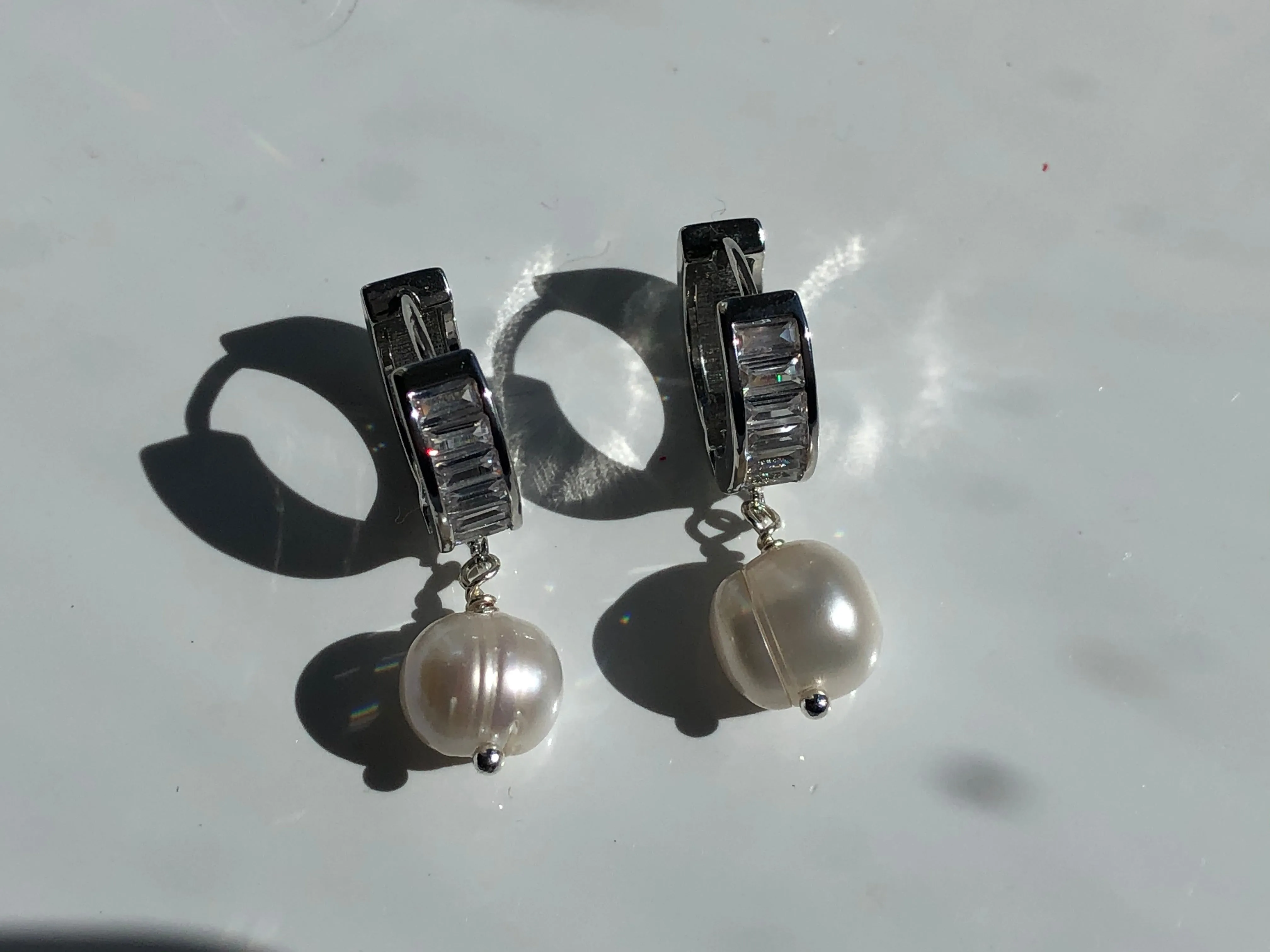 Earrings: Large single Pearl drop earrings on a baguette encrusted hoop - classic
